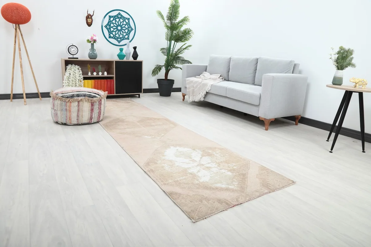 Angle view of the Anatolian runner rug with subtle rose and beige tones in a contemporary space