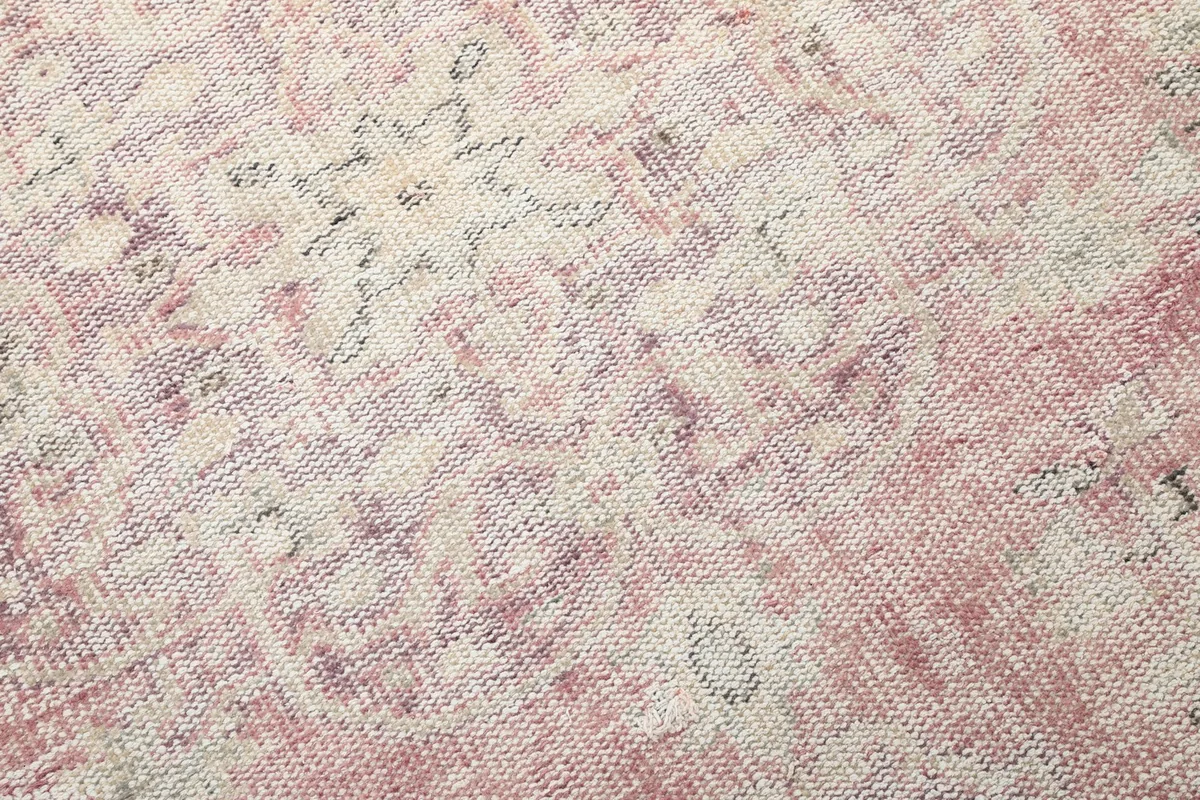 Detailed view of the hand-knotted wool pile, showing the texture and color variations of the rug