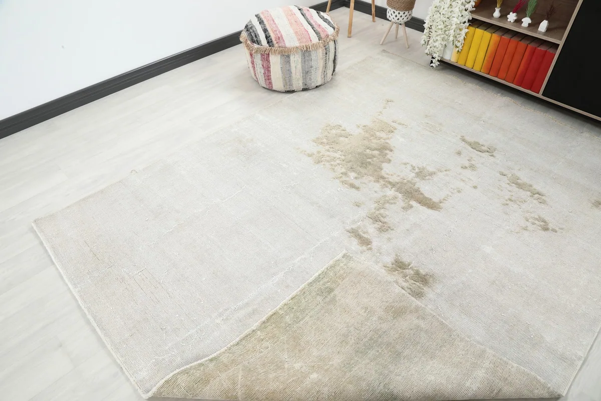 Rug folded back to reveal the underside, demonstrating the quality of the cotton foundation.