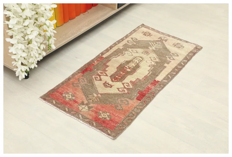 Full top view of the beige, rust, and brown vintage Anatolian rug on a white background.