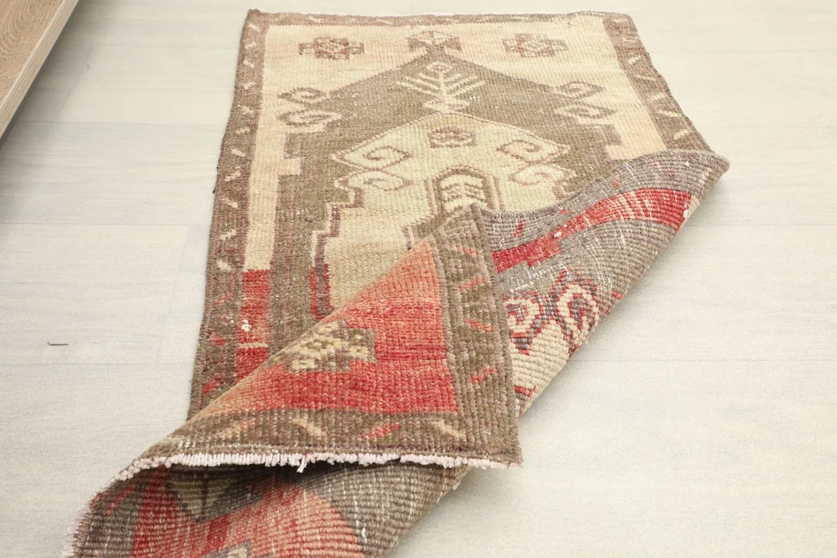 The rug partially folded, displaying its flexibility and construction.