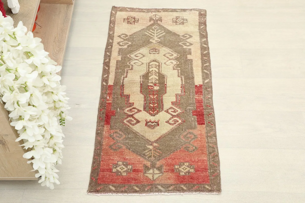 Overhead view of the small hand-knotted rug showing its full geometric design.