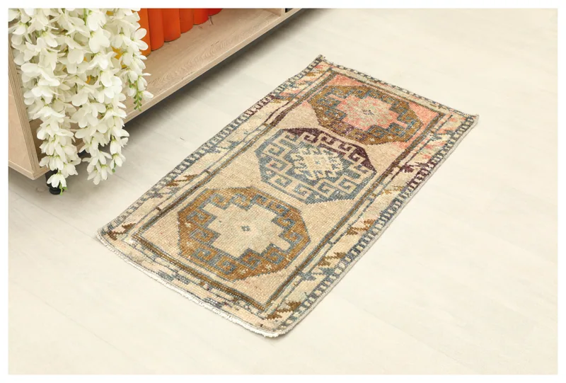 Full top view of the 2x3 beige tribal medallion vintage Anatolian doormat rug on a white background.