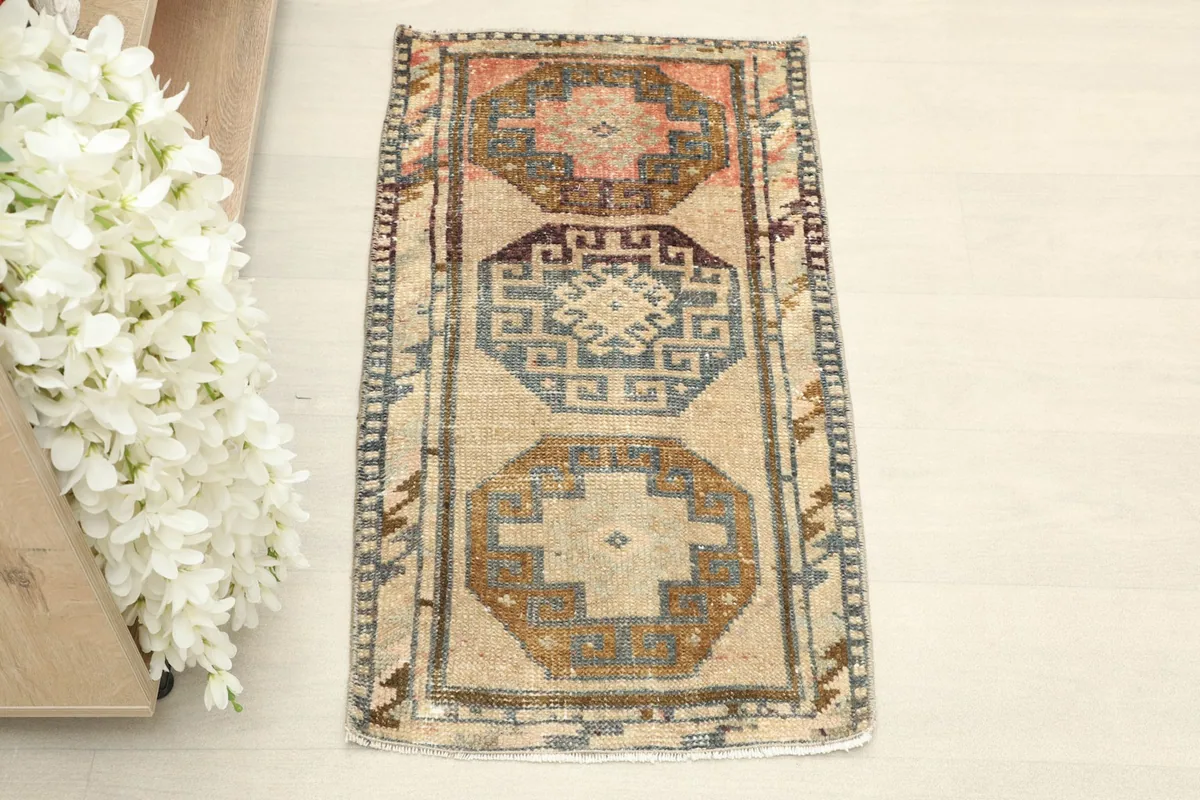 Straight overhead view of the beige doormat rug, showing its full design and colors.