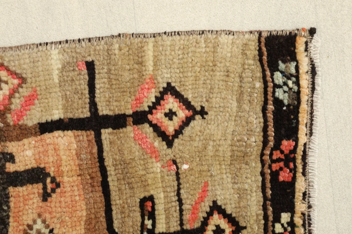 Close-up of the side edge, revealing the hand-knotted texture and color variations.