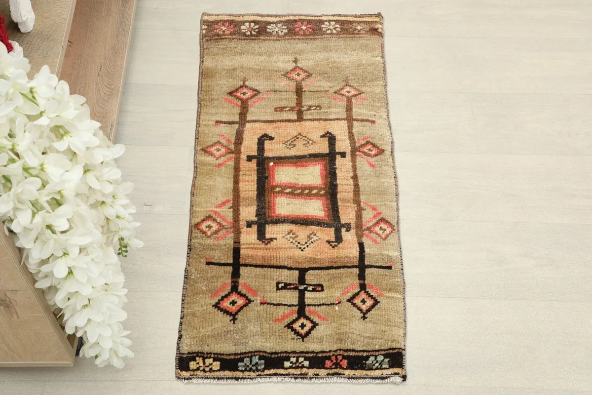 Overhead shot of the small hand-knotted rug, highlighting its balanced tribal design and colors.