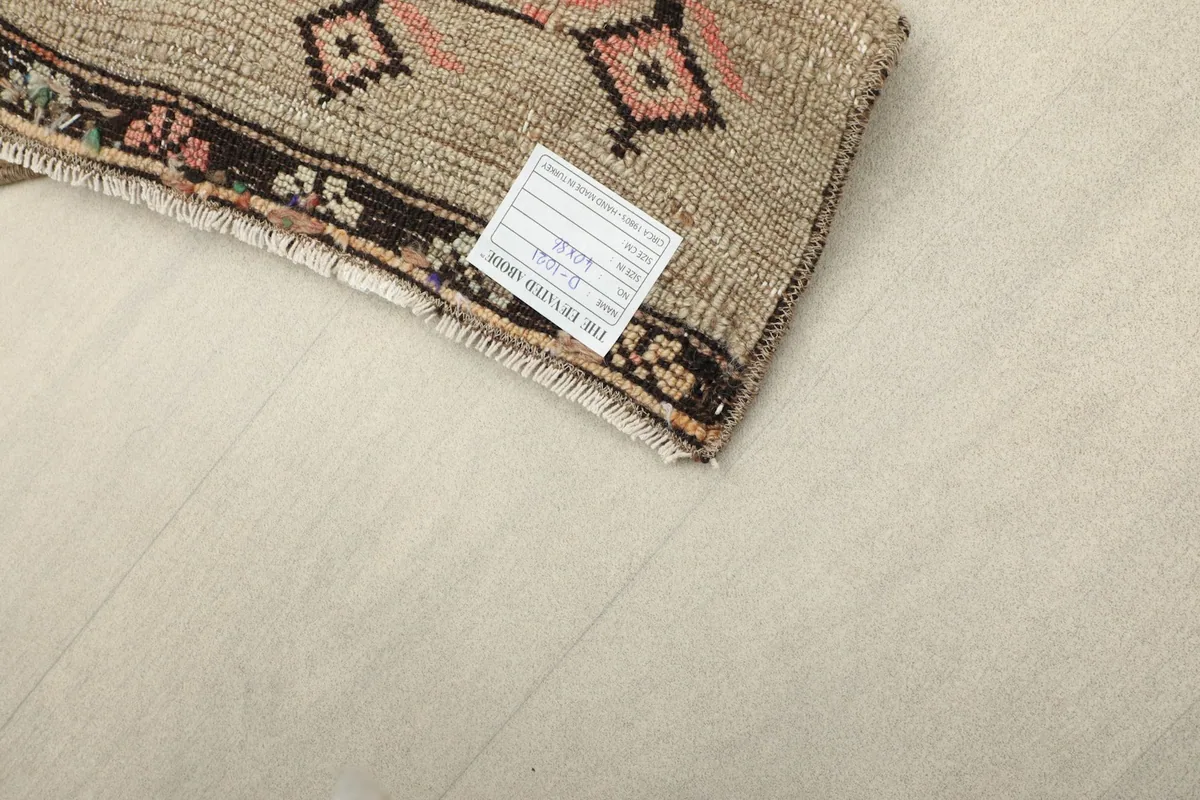 Overhead shot of the rug with its product label visible on the corner.