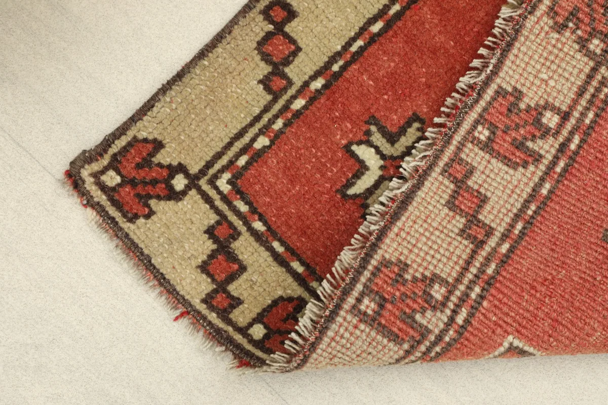 View of the low pile texture and the side selvedge, indicating the rug's construction