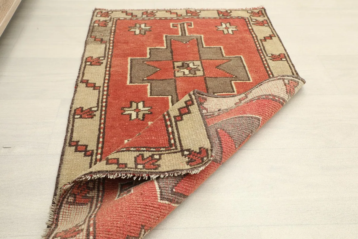 Partial view of the back of the rug, showing the cotton foundation and hand-knotted structure