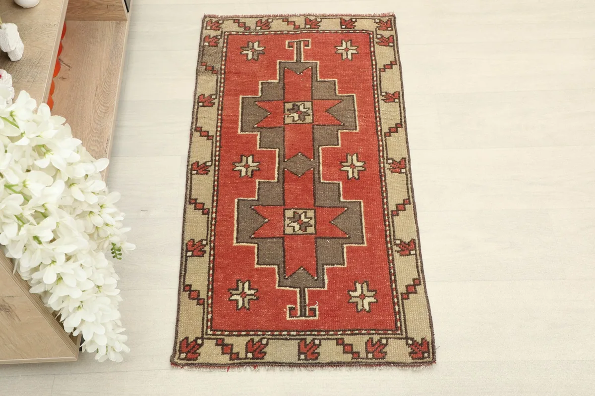 Overhead view of the vintage doormat, highlighting the symmetrical tribal design and colors