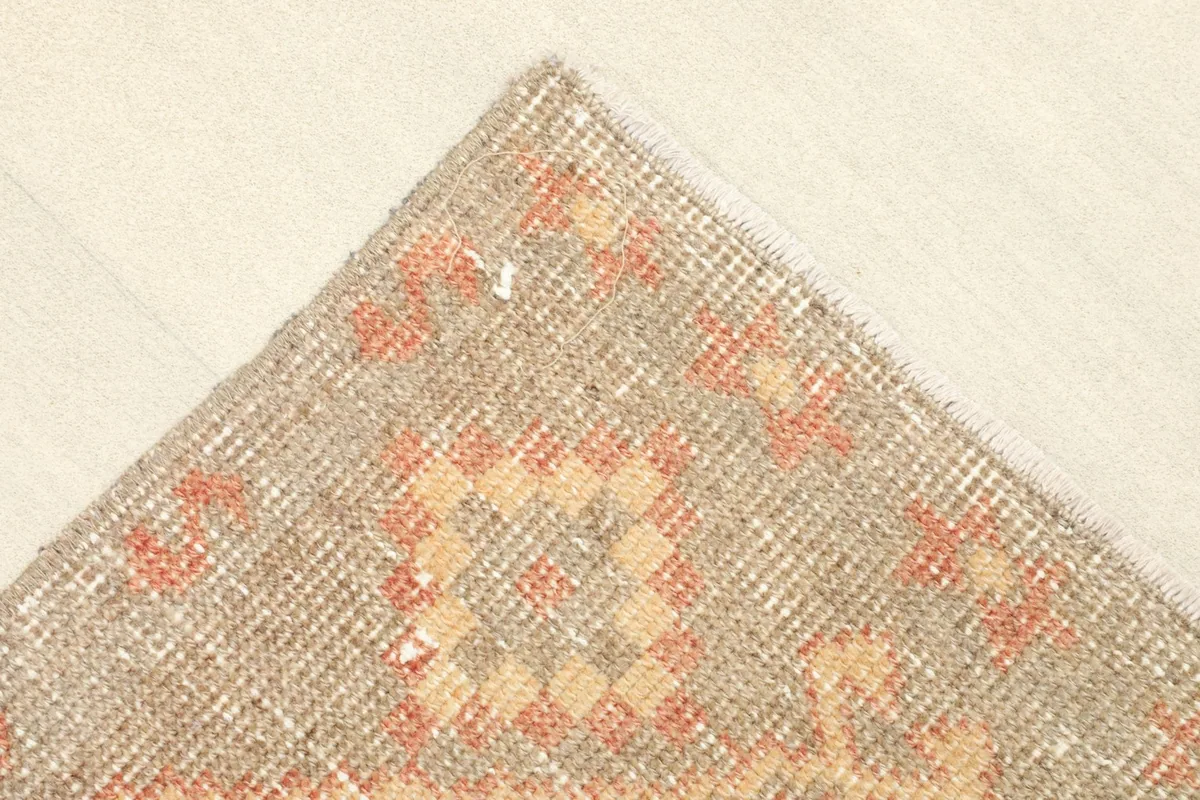 Close-up of a corner, showing the wool pile and subtle color variations.