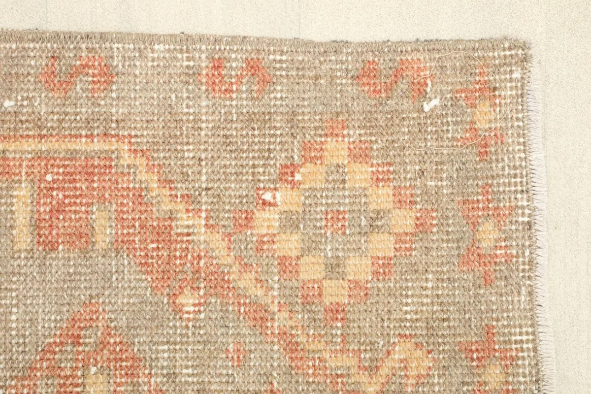 Detailed view of the rug's edge, revealing the hand-knotted construction.