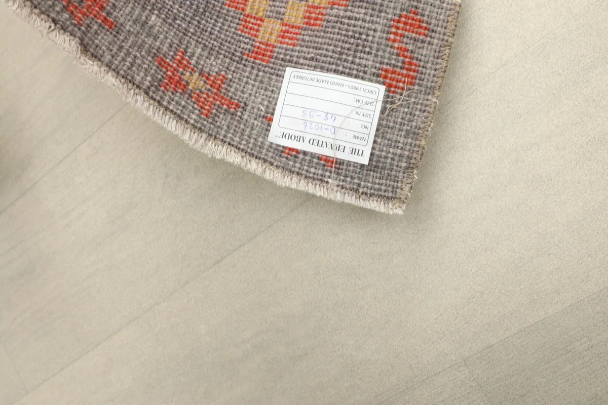 Close-up of the rug's back, revealing the tight knotting and foundation.