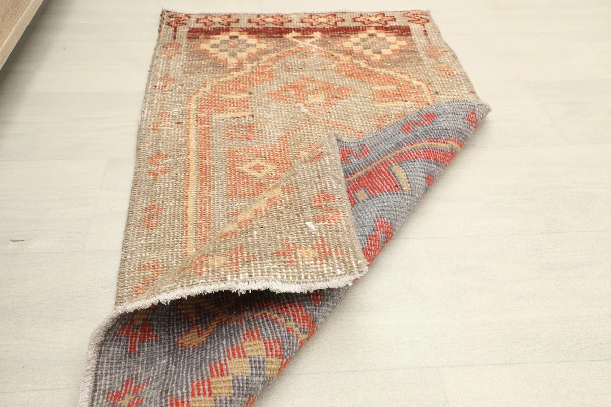 Partially folded rug displaying both the surface and the reverse side.