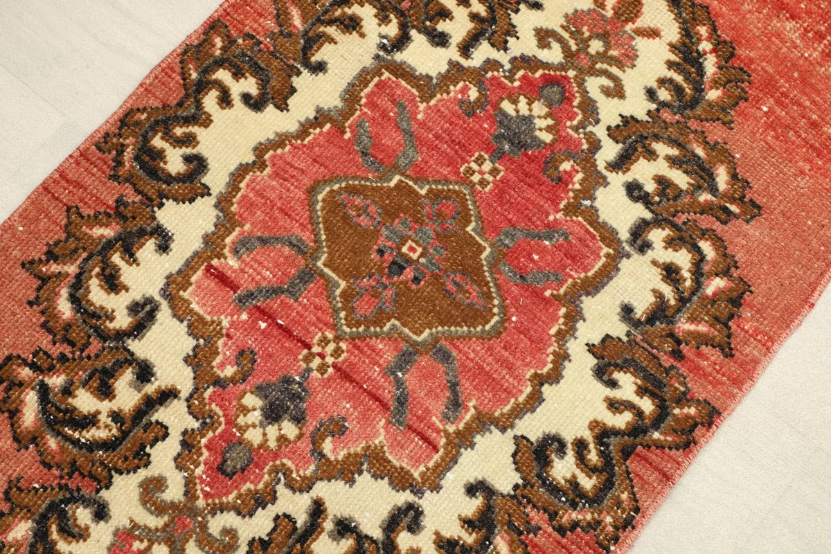 Close-up detail of the rust and ivory medallion pattern with brown and black accents