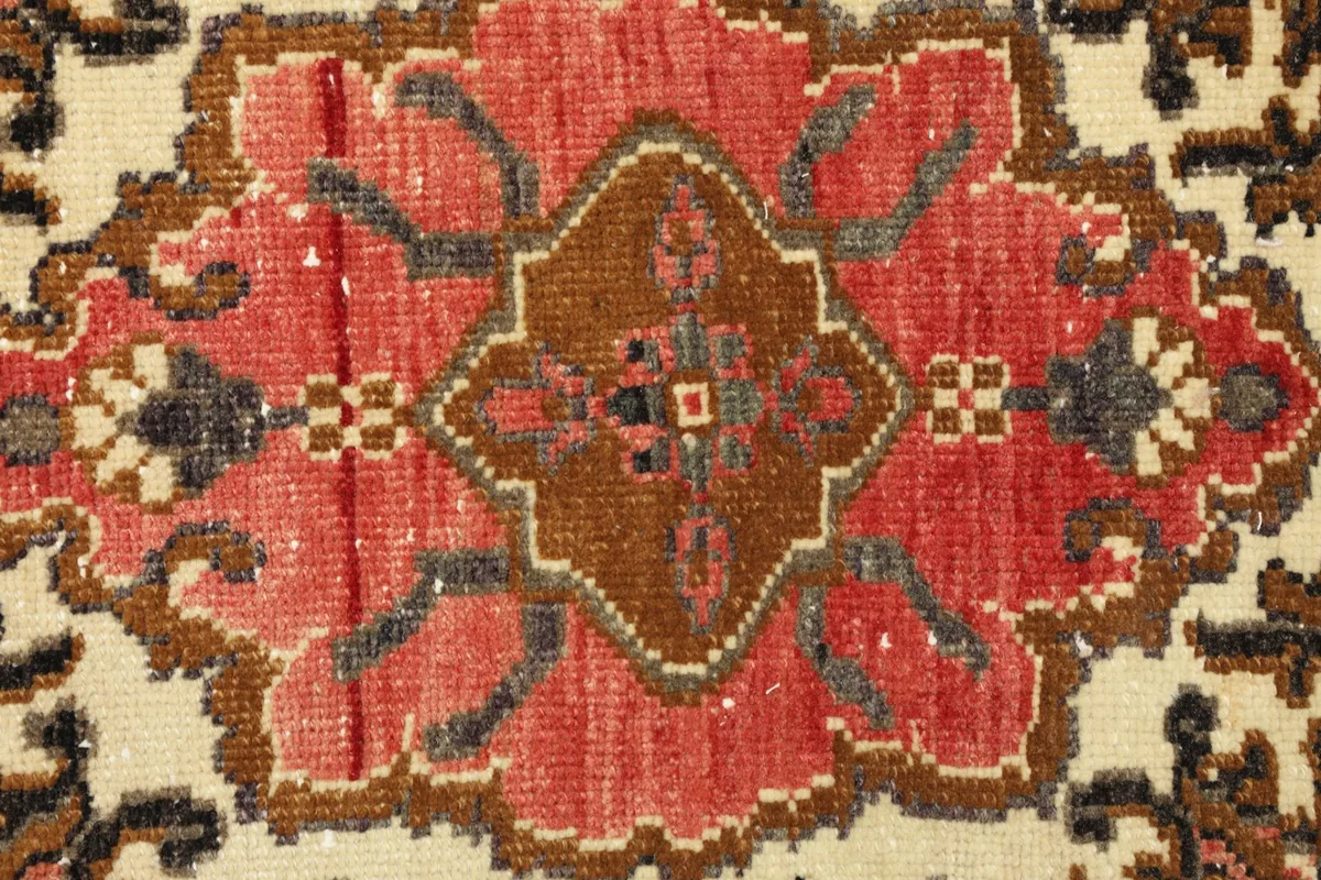 Detailed view of the central brown element within the medallion motif