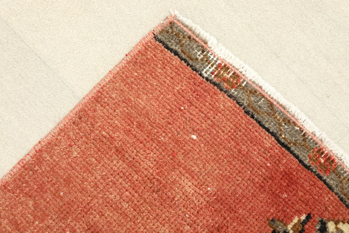 Corner detail showing the rust field and the subtle border design