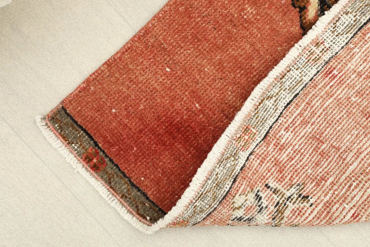View of the rug folded to reveal its wool pile on cotton foundation