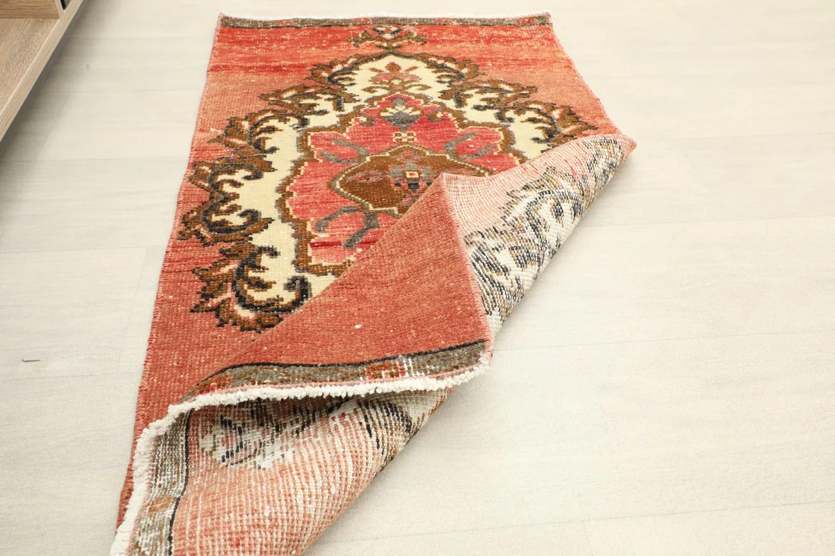 Another folded view, showing the back of the vintage hand-knotted rug