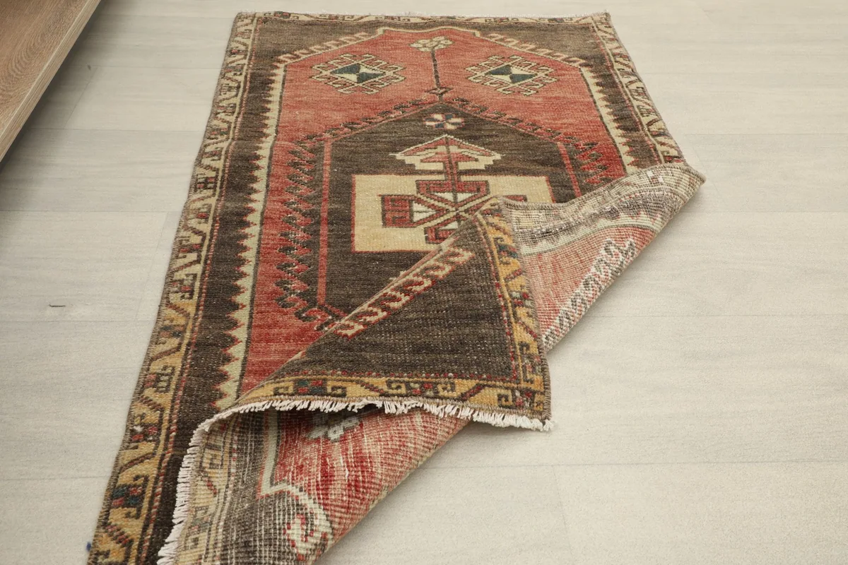 Rug partially folded, showing the thickness of the pile and the reverse side
