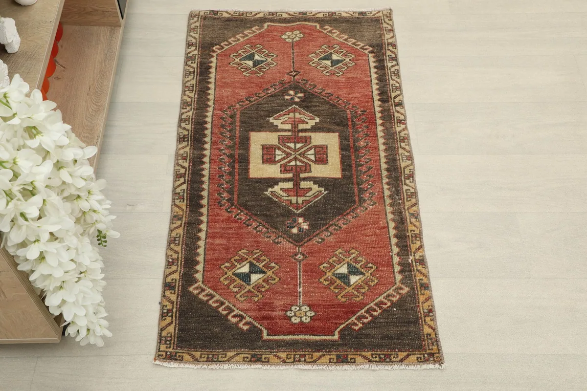 Overhead view of the vintage rust and brown wool rug, showcasing its full design
