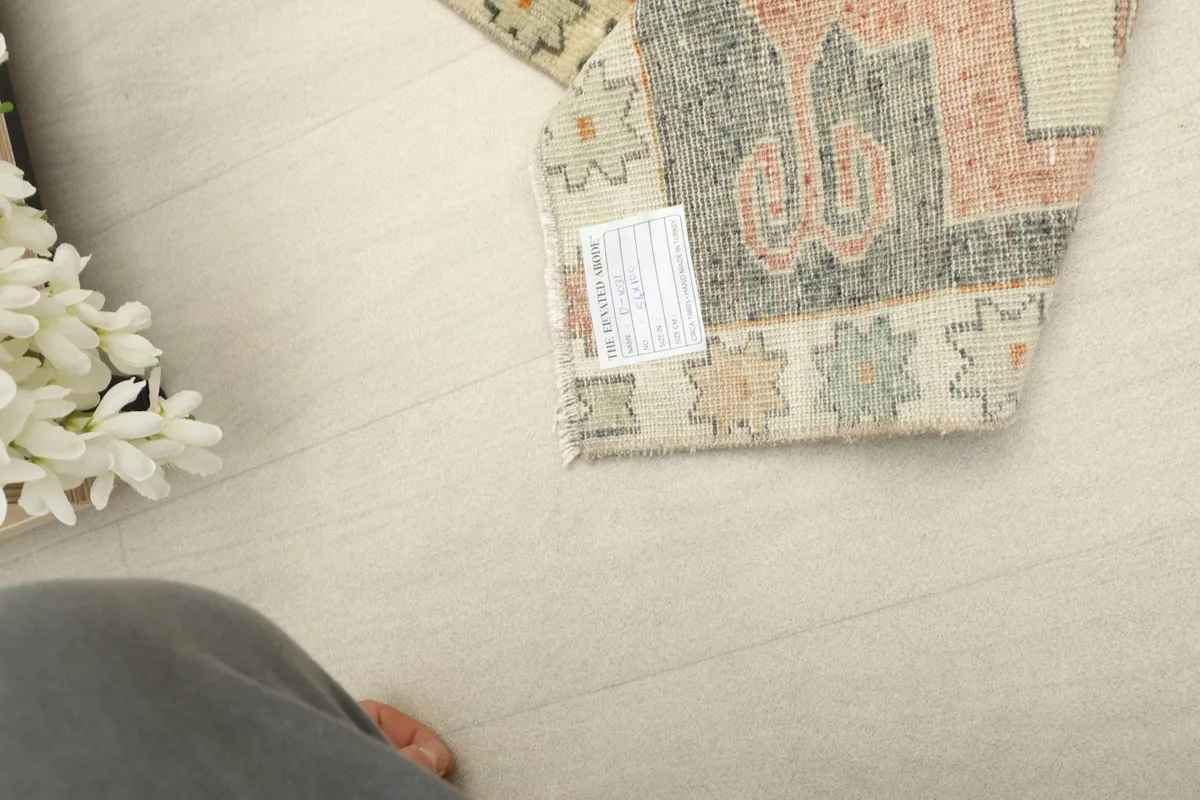 View of the back of the hand-knotted rug, showcasing the sturdy cotton foundation.