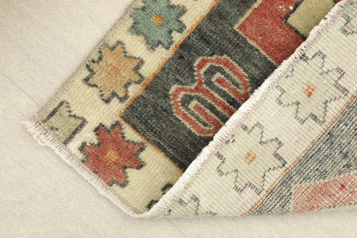 The rug folded to show the thickness and texture of the wool pile and cotton foundation.