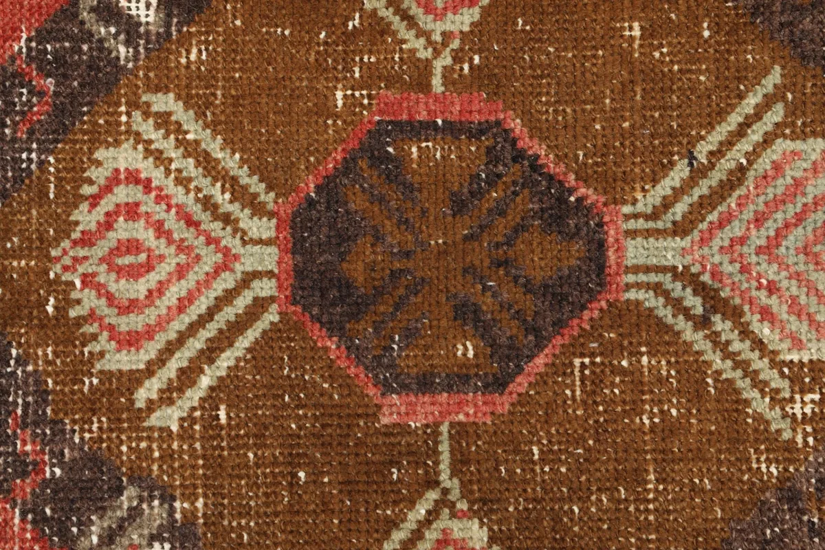 Tight detail shot of the central medallion's intricate geometric patterns and color variations.