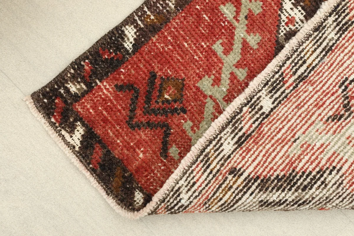View of the back of the hand-knotted wool rug, showing the cotton foundation and tight weave.