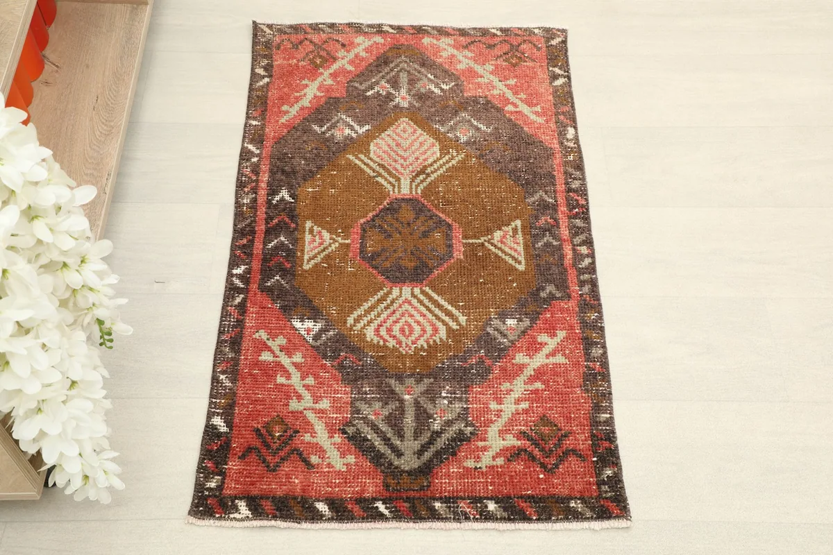 Overhead view of the hand-knotted rust and brown vintage wool rug, showcasing its full design.