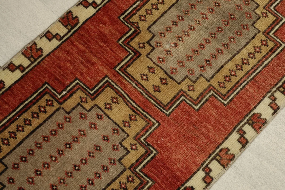 Angled view highlighting the central geometric medallions and color variations.