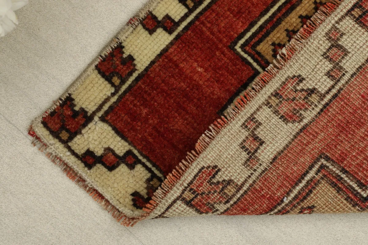 View of the rug folded, showing the thickness of the wool pile and cotton foundation.