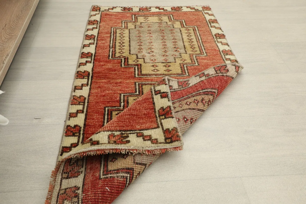 Another view of the rug partially folded, displaying the back and front textures.
