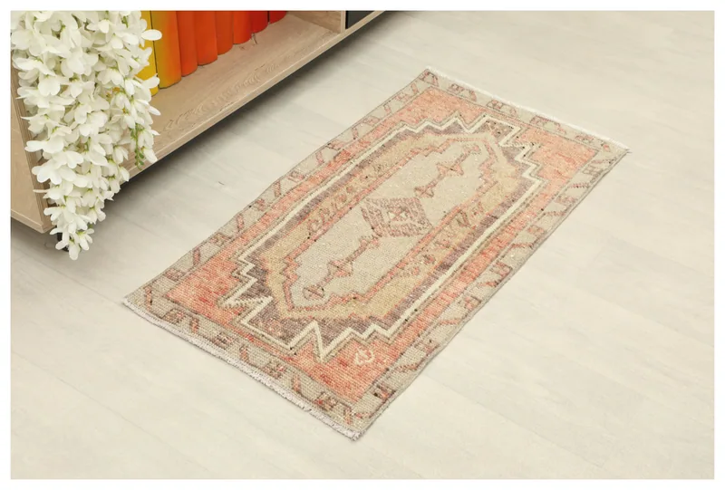 Full top view of the 1'8" x 3'1" beige and orange geometric vintage Anatolian doormat