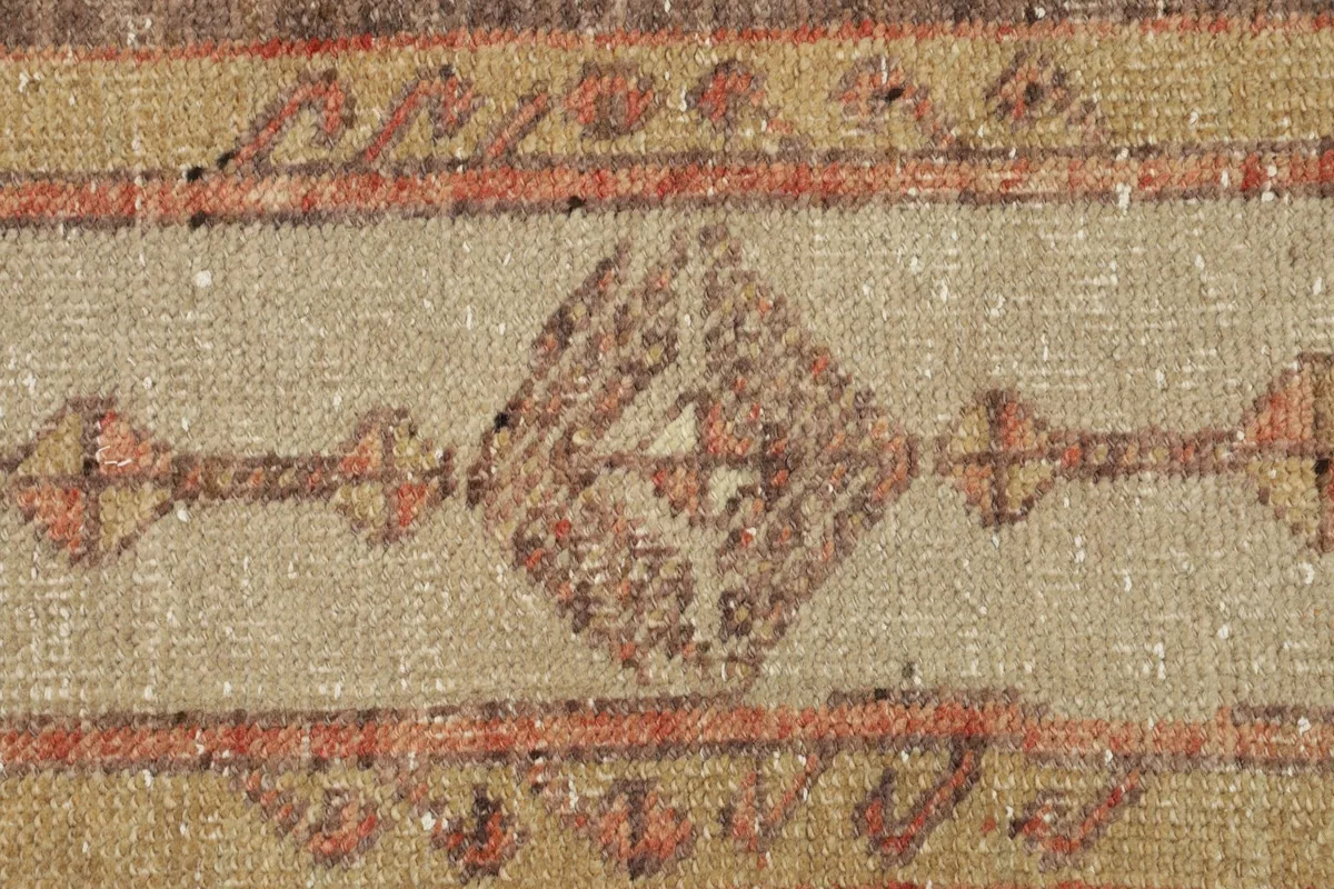 Close-up detail of the central diamond motif and surrounding tribal patterns