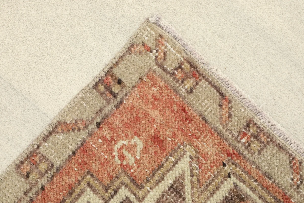 Close-up of a corner, showing the stepped border design and subtle color variations