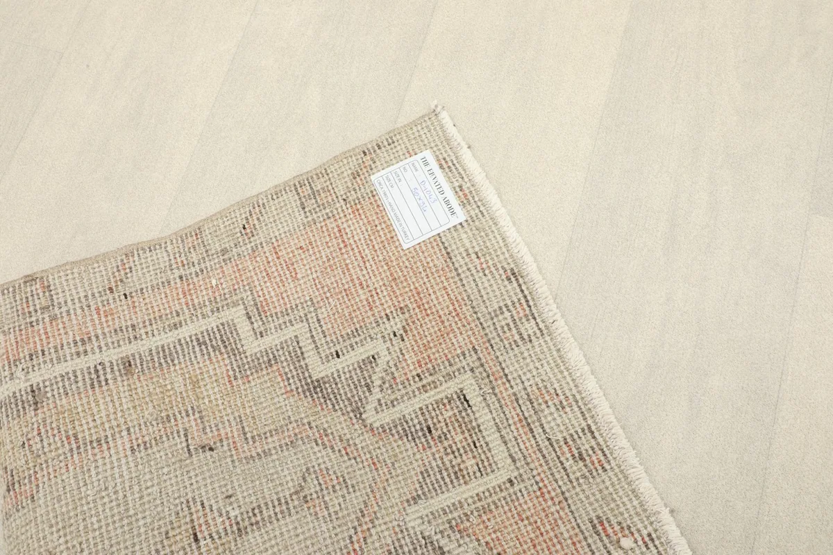 Back of the rug showing the hand-knotted construction and a small label