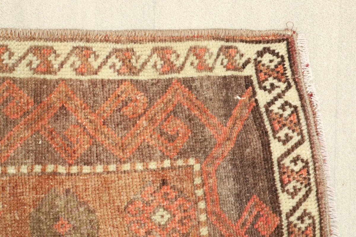 Detailed view of the border design and the geometric patterns within the rug's field