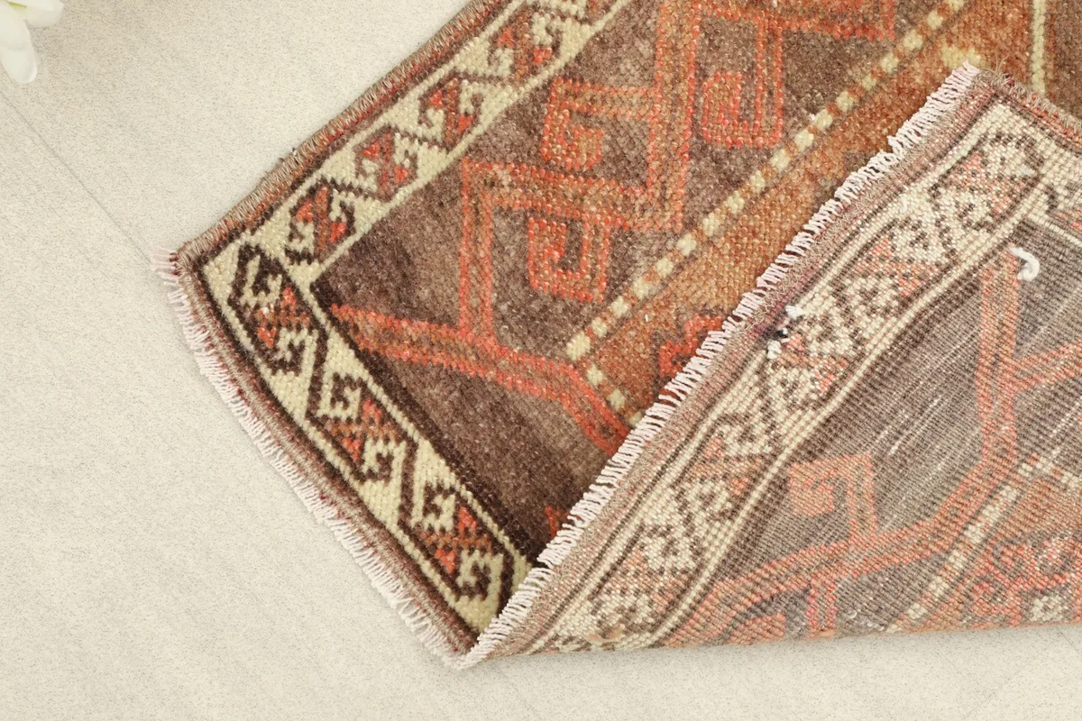 View of the rug folded, highlighting its flexibility and the texture of the wool pile