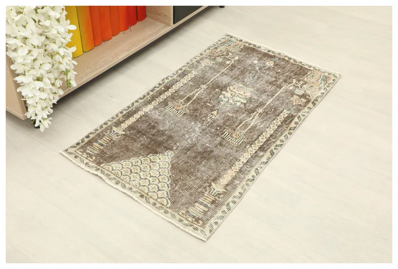Full top view of the brown geometric vintage Anatolian rug on a white background.