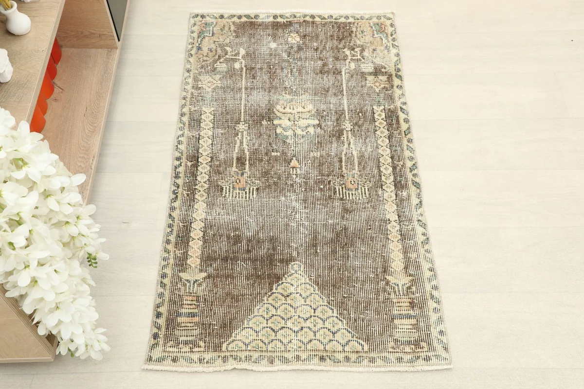 Overhead view showcasing the full design of the brown and beige vintage rug.
