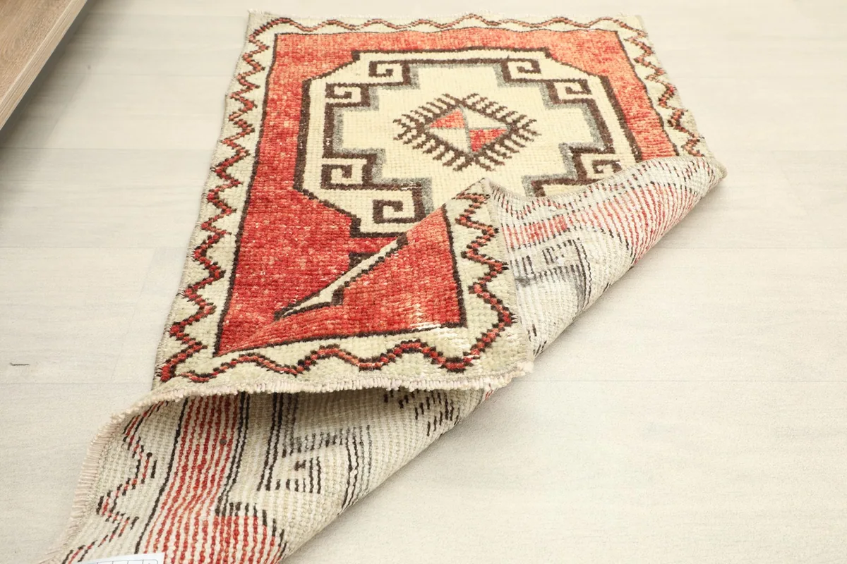 Partial view of the rug's underside, revealing the cotton foundation and hand-knotted details.