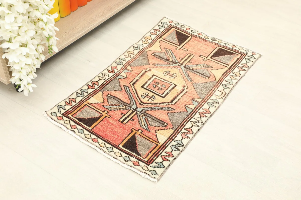Overhead view of the 2x3 rust vintage rug placed in a room setting, showcasing its size.