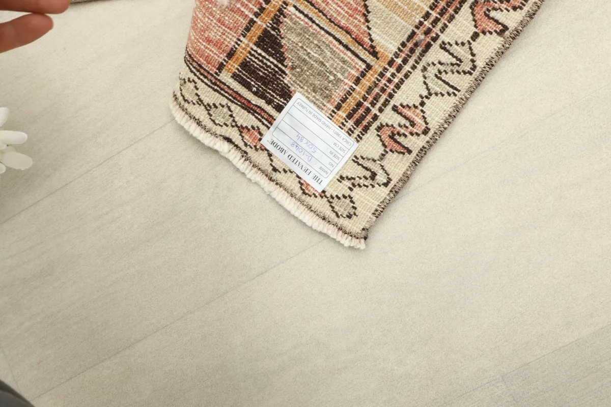 Underside view of the rug, revealing the cotton foundation and the hand-knotted structure.