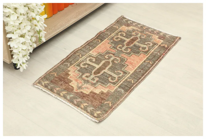 Full top view of the 2x3 brown and rust geometric vintage rug on a light floor