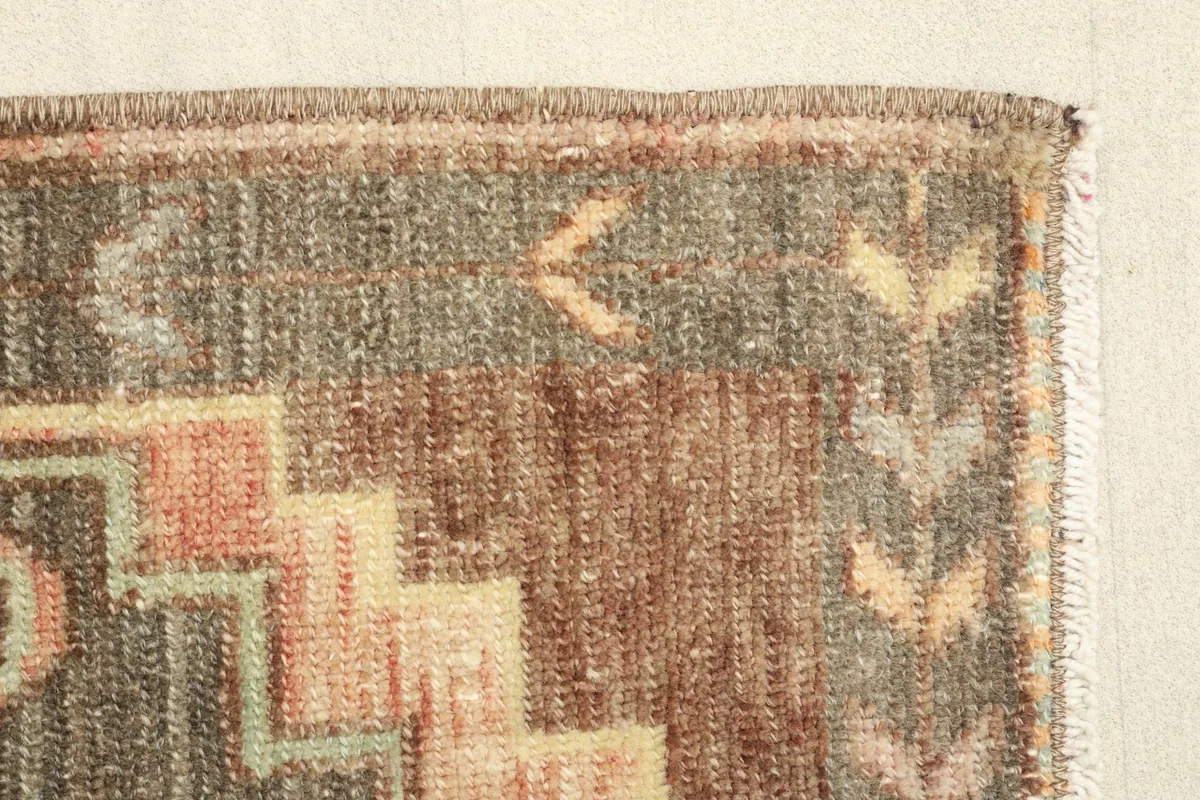 Close-up of the rug's border and main field, showing texture and subtle color variations