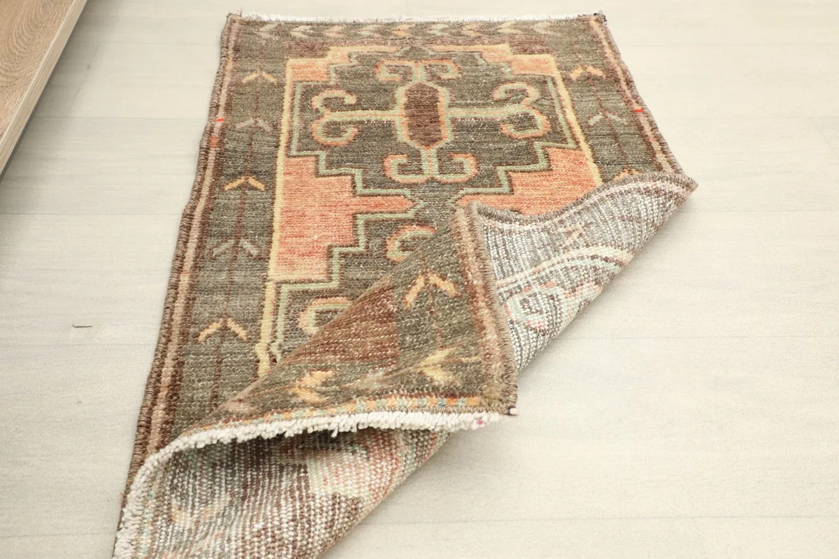 Partial view of the rug's reverse side, showing the hand-knotted cotton foundation