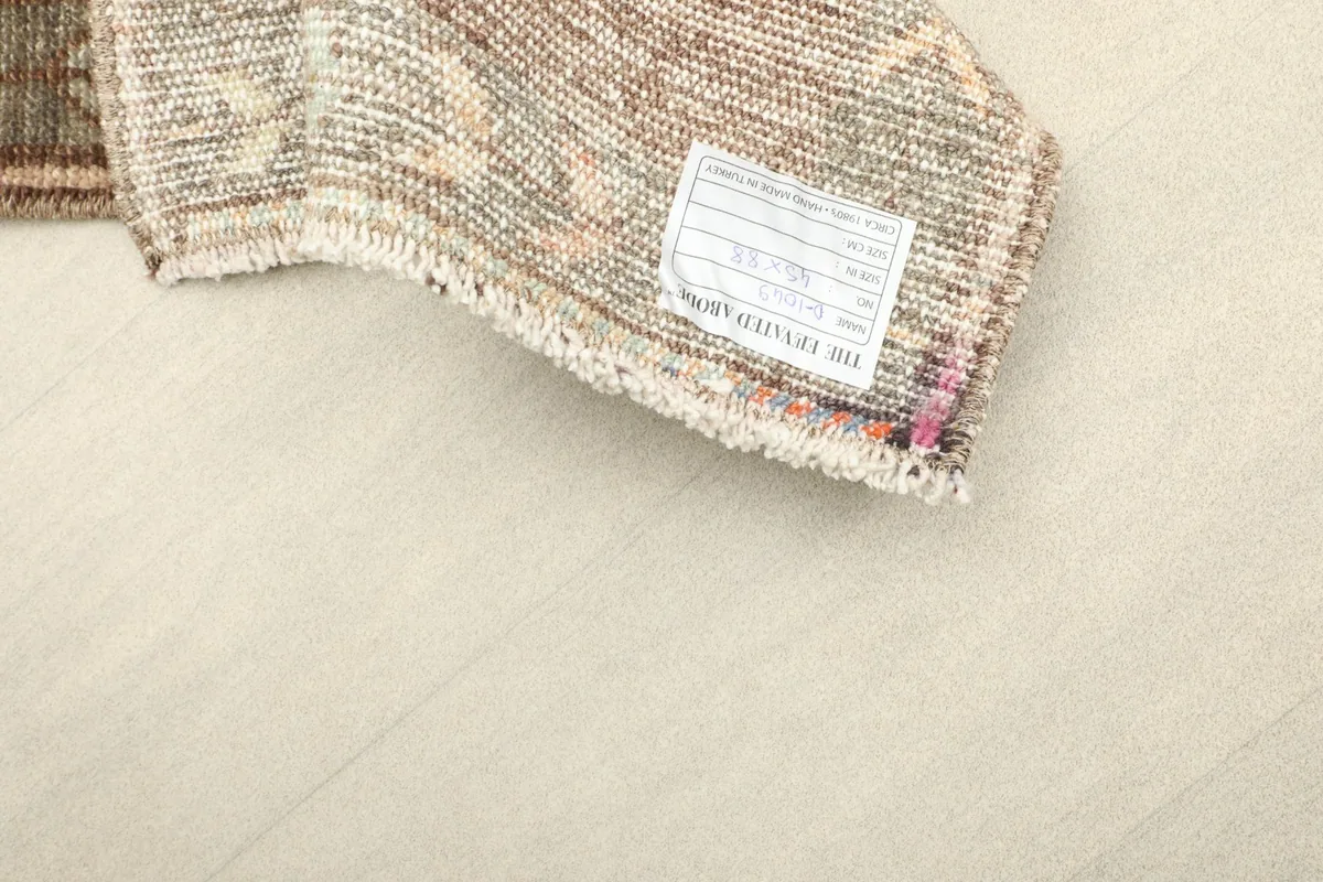 Close-up of the care tag attached to the back of the professionally cleaned vintage rug