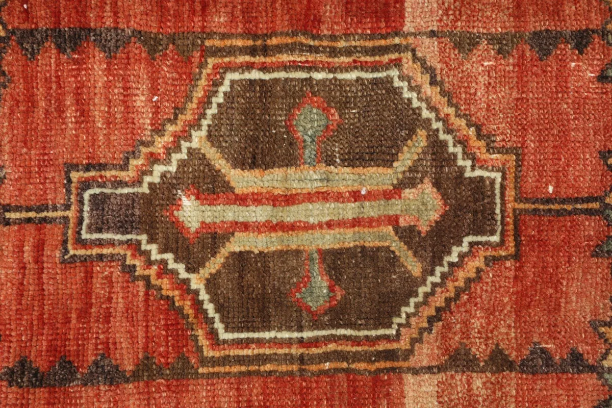 Close-up detail of the central geometric medallion with its intricate design and colors