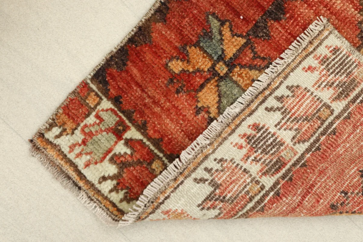 View of the rug folded, showing the cotton foundation and the reverse side